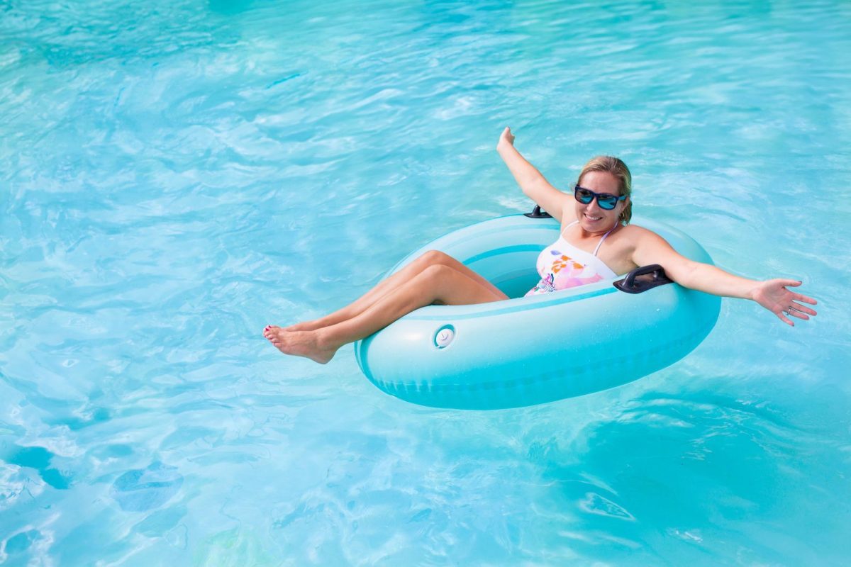 Woman in lazy river, floating in a tube